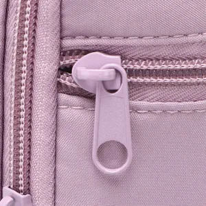 Close-up detail of purple waterproof travel water bottle bag zipper, durable fabric texture.