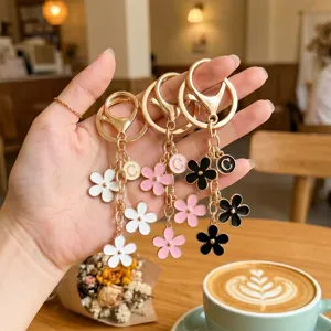 Chic metal floral initial C keychain and bag charm, stylish colorful flower pendant accessory.