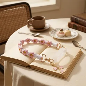 Handmade knitted floral cup strap with silicone ring and cute charms for water bottles.