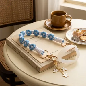 Detailed view of the handmade blue and white woven cup strap with metal clasp and silicone ring.
