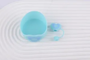 Silicone cup sleeve and heart straw cap detail shot, light blue dustproof accessory.