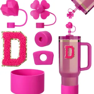Detail shot of pink silicone tumbler accessories set with straw covers, cup boot, and letter D.