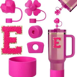 Pink Stanley cup accessories set with straw covers, letter patch and silicone boot.
