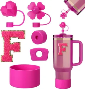 Pink Stanley cup accessories set including straw covers, letter patch and silicone boot.