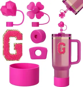 Pink Stanley cup accessories set including silicone straw covers, letter patch and cup boot.