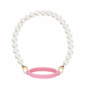 Pearl chain cup strap detail view, elegant white beads with gold clasps and pink silicone ring.