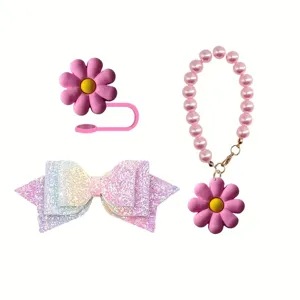 Stanley cup accessory detail, glitter bow, silicone straw cover and pearl chain pendant.