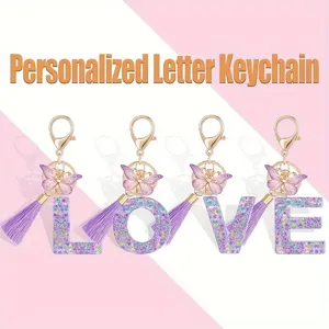 Detailed view of the personalized glitter resin letter keychain with cute butterfly and purple tassel.