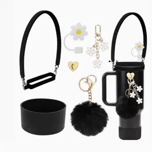 Tumbler accessory set with black strap, silicone boot, plush pom pom and flower charms.