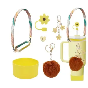 Stanley cup accessories set featuring colorful strap, flower straw cover, and plush pompom.