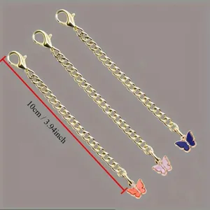 Close up detail of the golden butterfly hanging chain accessory showing the 10cm length and charms.