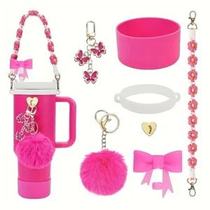 Pink tumbler accessory set with butterfly charms, plush pom-pom keychain, and braided straps.