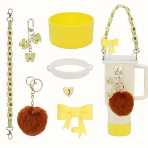 Detailed view of colorful butterfly crocheted daisy cup chains, fluffy pom poms, and bow charms.