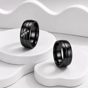 Stylish black stainless steel couple rings featuring dual grooves and diagonal crystal stones.