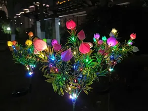 Nahaufnahme von solarbetriebenen Gartenblumenleuchten, die nachts im Hof hell leuchten.