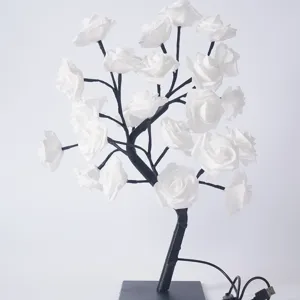 Gros plan de la lampe arbre roses blanches montrant des pétales délicats et des branches.