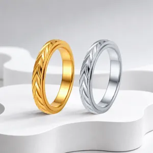 Closeup of retro spinner ring with detailed wheat carving in gold and silver finish.