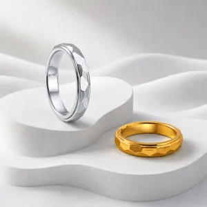 Close-up detail of trendy stainless steel multi-faceted spinner ring with smooth rotation.