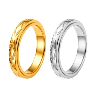 Stainless steel spinner ring with carved leaf pattern, dual tone gold and silver fashion jewelry.