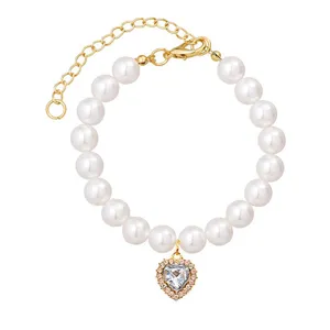 Cute pet pearl necklace with crystal heart pendant and adjustable gold chain for cats and small dogs.