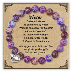 Close-up detail of the purple impression jasper bead bracelet with a sister heart charm card.