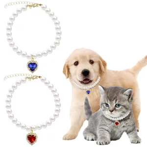 Pet pearl necklace detail showing cute heart crystal pendant and adjustable golden chain links.