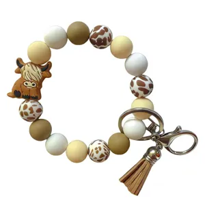 Porte-clés en perles de silicone avec charm charmant de vaches des Highlands et pompon.