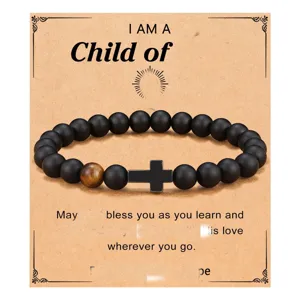 Black obsidian and tiger eye stone bead bracelet with cross pendant detail view.