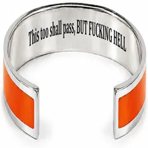 Stainless steel open cuff bracelet with vibrant orange enamel inlay and engraved motivational text.