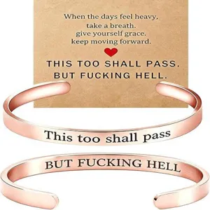 Stainless steel open cuff bracelet with inspirational engraved text, stylish rose gold finish.