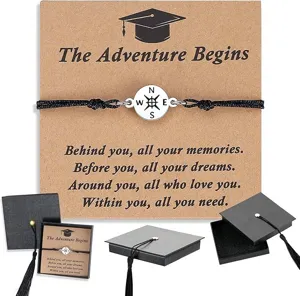 Graduation compass braided bracelet detail view with greeting card and gift box for students.