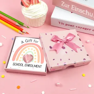 Pink crystal heart gift box detail view with cute rainbow card and ribbon bow decoration.