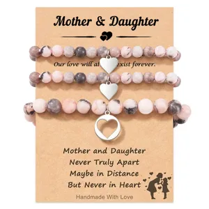 Mother and daughter beaded bracelet set with heart charms, matching pink natural stone jewelry.