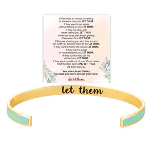 Detailed view of gold stainless steel cuff bracelet with mint green enamel and engraving.