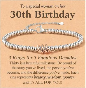 Close-up detail of silver beaded 30th birthday bracelet featuring three rose gold rings.