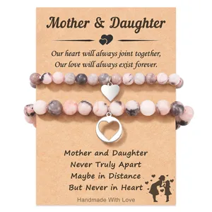 Mother and daughter beaded bracelet set with heart pendants on card for special gift