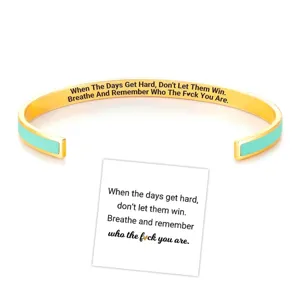 Stainless steel open cuff bracelet with motivational quote engraving and elegant enamel inlay.