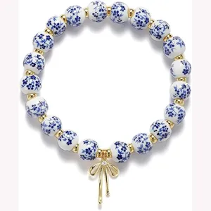 Blue and white porcelain ceramic beaded bracelet with gold bow pendant for women and girls
