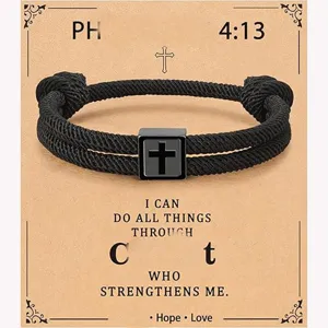 Detailed view of the handmade black Milan rope bracelet featuring a stainless steel cross charm.