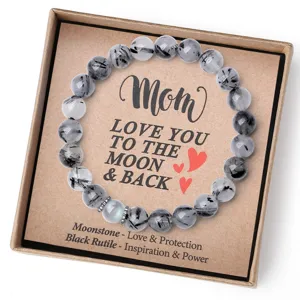 Vue détaillée du bracelet de perles en quartz rutilé noir et pierre de lune dans un joli coffret.