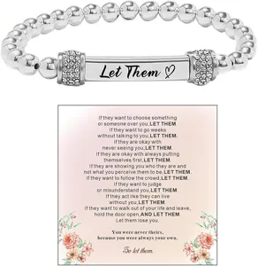 Stainless steel beaded stretch bracelet detail featuring engraved Let Them metal bar with crystals.