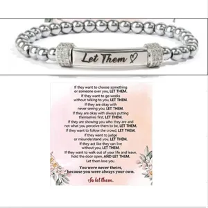 Stainless steel bead bracelet with engraved bar and inspirational quote card, detail view of fashion jewelry.