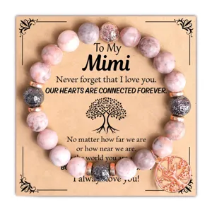 Detailed shot of pink beaded bracelet with rose gold tree charm and greeting card.