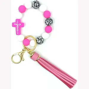 Porte-clés perles en silicone avec croix rose et gland pour bracelet élégant femme