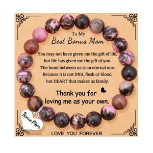 Detailed close-up of rhodochrosite gemstone bead bracelet with bonus mom heart pendant.