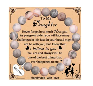 Detailed view of the daughter beaded bracelet with heart charm and sentimental message card.
