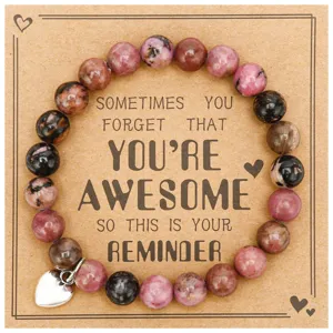 Detailed view of a handmade beaded gemstone bracelet with a stainless steel heart charm card.