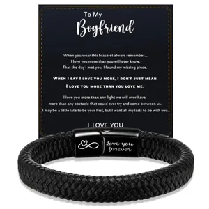 Close-up detail of black braided leather men's bracelet with stainless steel magnetic clasp.