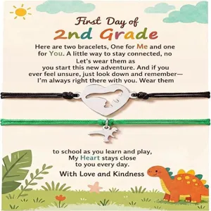 Detail view of the stainless steel dinosaur matching bracelets set on a cute card.