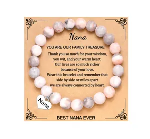 Detailed view of the beaded bracelet with engraved heart charm and heartwarming message card.
